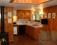 living area with sofa, cable tv; kitchen - microwave, coffee maker, refrigerator-freezer, oven-stove, dishwasher. 