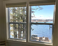 View from queen bedroom with benches at the shore looking northwest to Bernard