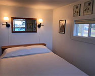 queen bedroom showing the cove from the porch on the right. Bass Harbor is reflected in the mirror.